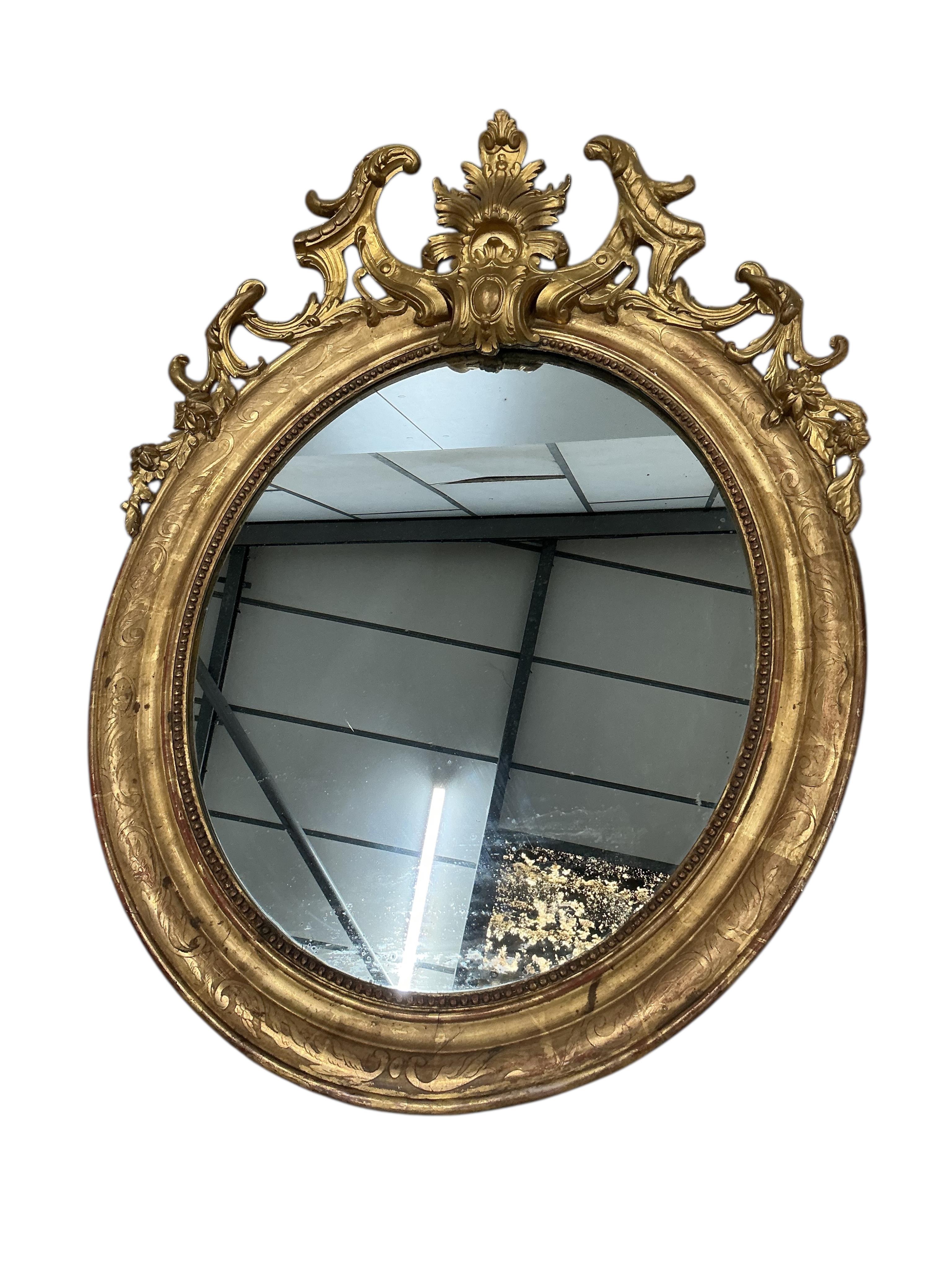 A pair of 19th century French giltwood and composition oval wall mirrors, width 68cm, height 91cm